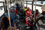 City bus traveling along Broad St. by Lincoln Park, Newark. On the woman's red t-shirt reads: "Ambrose slapped me like a slave"