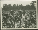 Two white and four African-American men in fields of tobacco