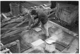 Worker steam-cleaning floor mats, 14th Street passenger yards, Chicago, May 1948