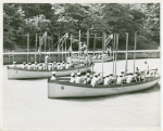 Three crews of African American sailors sitting in their cutters at the end of a boat drill session, U.S. Naval Training Station