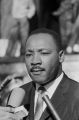 Martin Luther King Jr. speaking to journalists outside the Dallas County courthouse in Selma, Alabama, during a civil rights demonstration.