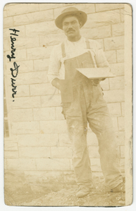 Photograph of Henry Durr holding masonry tools