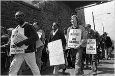 Sanitation workers strike supporters marching on Martin Luther King Jr. Drive in downtown Atlanta, Georgia, March 28, 1970. Photograph is part of a series labeled "Strike march."