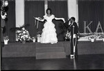 Theta Alpha Omega Chapter, AKA, Sorority debutante posing with her escort, Los Angeles, 1983