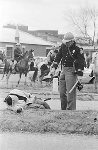 Alabama state trooper standing over Amelia Boynton after she was knocked down during the attack on civil rights marchers on Bloody Sunday in Selma, Alabama.