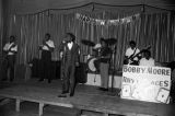 Members of Bobby Moore and the Rhythm Aces performing on stage at the Laicos Club in Montgomery, Alabama, during a New Year's celebration.