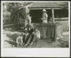 Sharecopper family sitting by sled at barn near Manning, S.C.