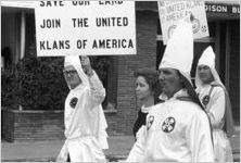 Klansmen and other marchers carrying signs in a parade during a Ku Klux Klan rally in Montgomery, Alabama.