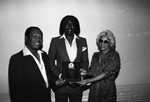 Benjamin Wright holding an award at the Pied Piper nightclub, Los Angeles, 1984