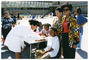 Woman Performing Blood Work at Health Fair