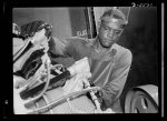 Production. Aircraft engines. A young Negro worker stands ready to wash or "degrease" this airplane motor prior to its shipment. He's an employee of a large Midwest airplane plant. Melrose Park, Buick plant