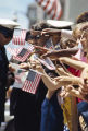 Spectators waving American flags at the Veterans Day parade in Birmingham, Alabama.