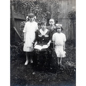 Family portrait, Florence Glover reads with her children