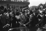 Woman and two men walking beside a car down Auburn Avenue toward Ebenezer Baptist Church for Martin Luther King, Jr.'s funeral.