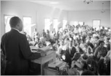 Martin Luther King, Jr., speaking to an audience in a church building, probably First Baptist Church in Eutaw, Alabama.