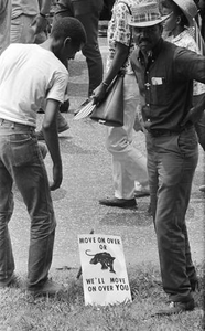 Two men standing beside the street near the end of the March Against Fear in Jackson, Mississippi.