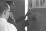 Young man from Bessemer High School discussing a math problem with his tutor in the basement of St. Paul's Lutheran Church in Birmingham, Alabama.