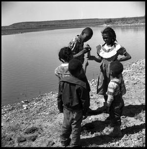 Children on a Bank with a Catfish