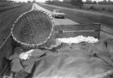 Trailer full of cotton being pulled by a tractor down a paved road near Mount Meigs in Montgomery County, Alabama.