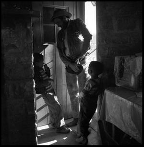 Children with a Cowboy in a Doorway