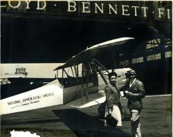 Chauncey Spencer and his sister Alroy Spencer Rivers in New York City, beside NAAA biplane flown cross-country by Spencer & White, May 1939