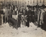 Grand prize winner at the second annual "Sears' Cow-Hog-Hen Project," shaking hands with a man in front of the Sears, Roebuck and Co. store in Montgomery, Alabama.