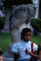 Student standing in front of sculpture