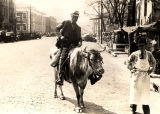 African American man riding bull on Madison Avenue in Montgomery, Alabama.