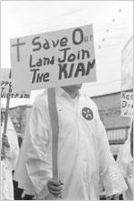 Klansmen carrying signs in a parade during a Ku Klux Klan rally in Montgomery, Alabama.