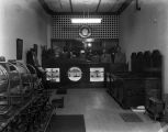 Staff standing behind the counter of the Goodyear shoe repair shop in Montgomery, Alabama.