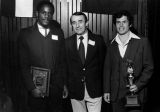 Joseph Born poses with two soccer players at an awards ceremony, 1976-1982