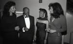 Willie Brown speaking with three unidentified woman at a formal event, Los Angeles, 1989