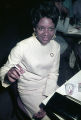 Mary Corbin seated at a table at the Laicos Club in Montgomery, Alabama.