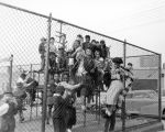 Mostly African-American and Asian-American children playing on a school playground, Seattle, 1951