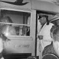 Police officers at the door of a school bus during the attempted integration of several high schools in Macon County, Alabama.