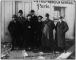 Group of men in front of French construction shed