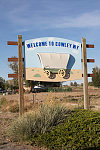 Welcome sign featuring a covered wagon in Cowley, Wyoming. Such wagons were once a common sight in the hills and valleys nearby during the great westward migration of settlers heading toward Oregon in the 19th Century