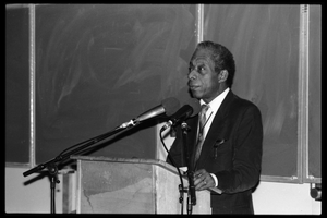 James Baldwin lecturing at UMass Amherst Baldwin standing at a podium with microphones