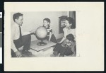 David Hyun and his family look at a globe, circa 1950, Los Angeles