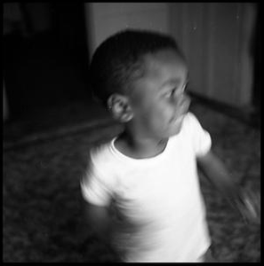 Young Boy Standing on a Rug