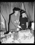 Thumbnail for PRESS WOMEN FETE MRS. ROOSEVELT ON 54TH BIRTHDAY. WASHINGTON, D.C.OCTOBER 11. CELEBRATING HER 54TH BIRTHDAY TODAY, MRS. FRANKLIN D. ROOSEVELT WAS ENTERTAINED AT A SPECIAL LUNCHEON IN HER HONOR BY MEMBERS OF THE WOMEN'S NATIONAL PRESS CLUB. THE FIRST LADY IS PICTURED CUTTING HER BIRTHDAY CAKE, WHICH INCIDENTLY CONTAINEDONLY 21 CANDLES. MISS HOPE RIDINGS MILLER, PRESIDENT OF THE CLUB, IS ON THE LEFT