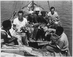 "34th CB's trading with natives from Malaita. Left to right: native; Percy J. Hope, MS2c; Lilton T. Walker, S1c; two natives; Jack Kelsen, SC1c."