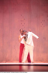 Dancer in red touching groom dancer