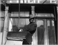 Elderly African American man sitting in the driver's seat of a wagon, Atlanta, Georgia, 1916