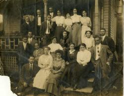 Group posed on front porch steps of Alpha Phi Alpha House, 1017 Catherine St. Ann Arbor