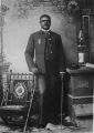 Studio portrait of African American officer with chair and cane, Company A, 25th United States Infantry Regiment "Buffalo Soldiers", Fort Custer, Montana, ca. 1889