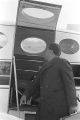 Hosea Williams holding a briefcase and looking inside the door of a plane at the airport in Montgomery, Alabama.