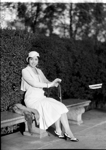 Mme. Evanti [Lillian Evans Tibbs, sitting on bench in park : acetate film photonegative]