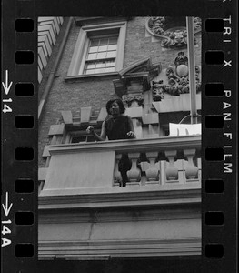 Student seen outside on balcony of Boston University administration building during sit-in