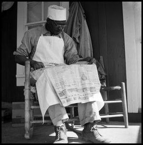 Oliver Jacobs Reading a Newspaper Titled The Black Dispatch